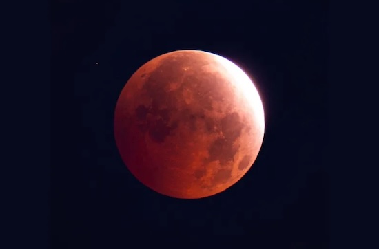 Partial lunar eclipse stuns skywatchers with ‘almost blood moon’